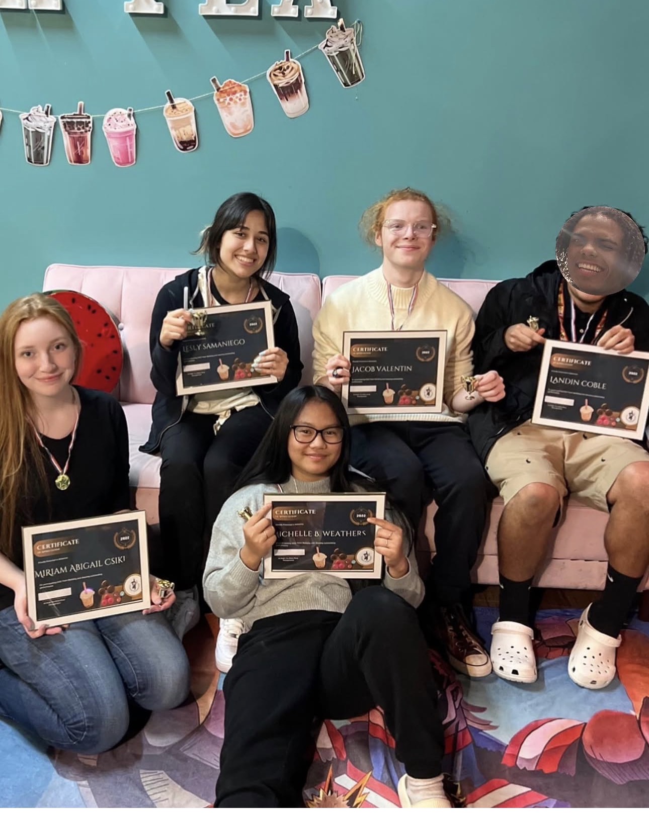 Team celebrating with certificates at All Migh-Tea