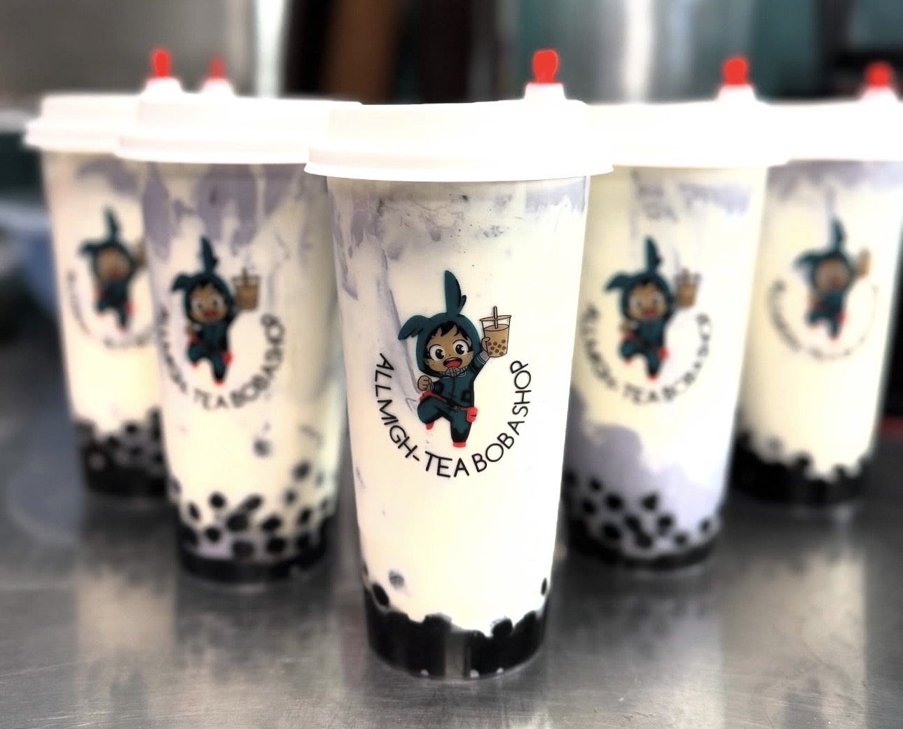 Brown sugar boba cups with All Migh-Tea logo